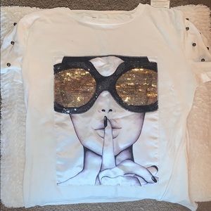 This women shhhh top with big gold sunglasses